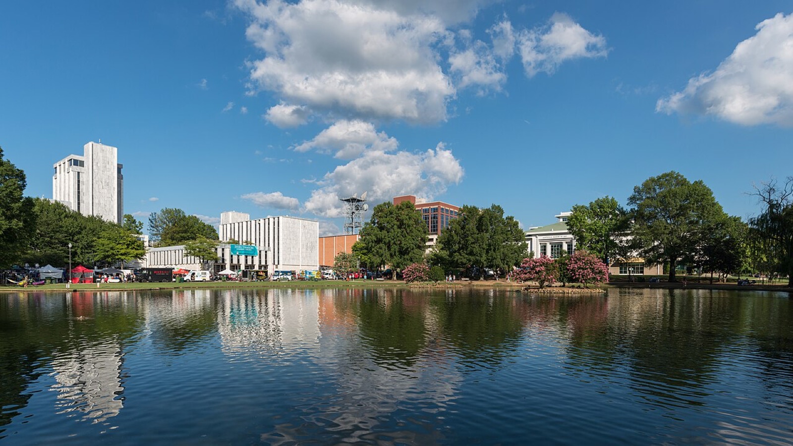 Big Spring International Park lake and downtown Huntsville buildings in daylight